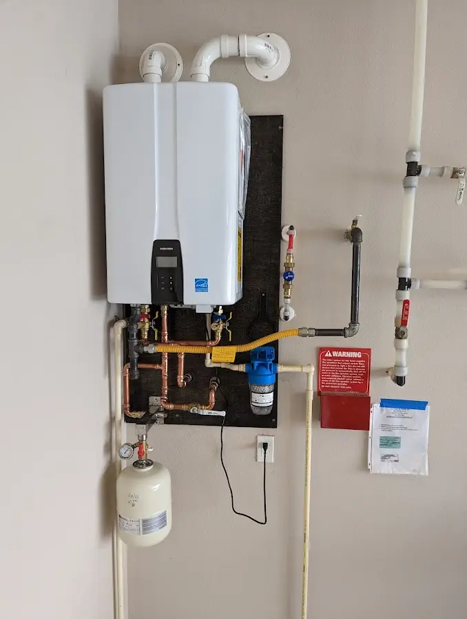 Professional plumber installing copper piping in a Cannon Falls home